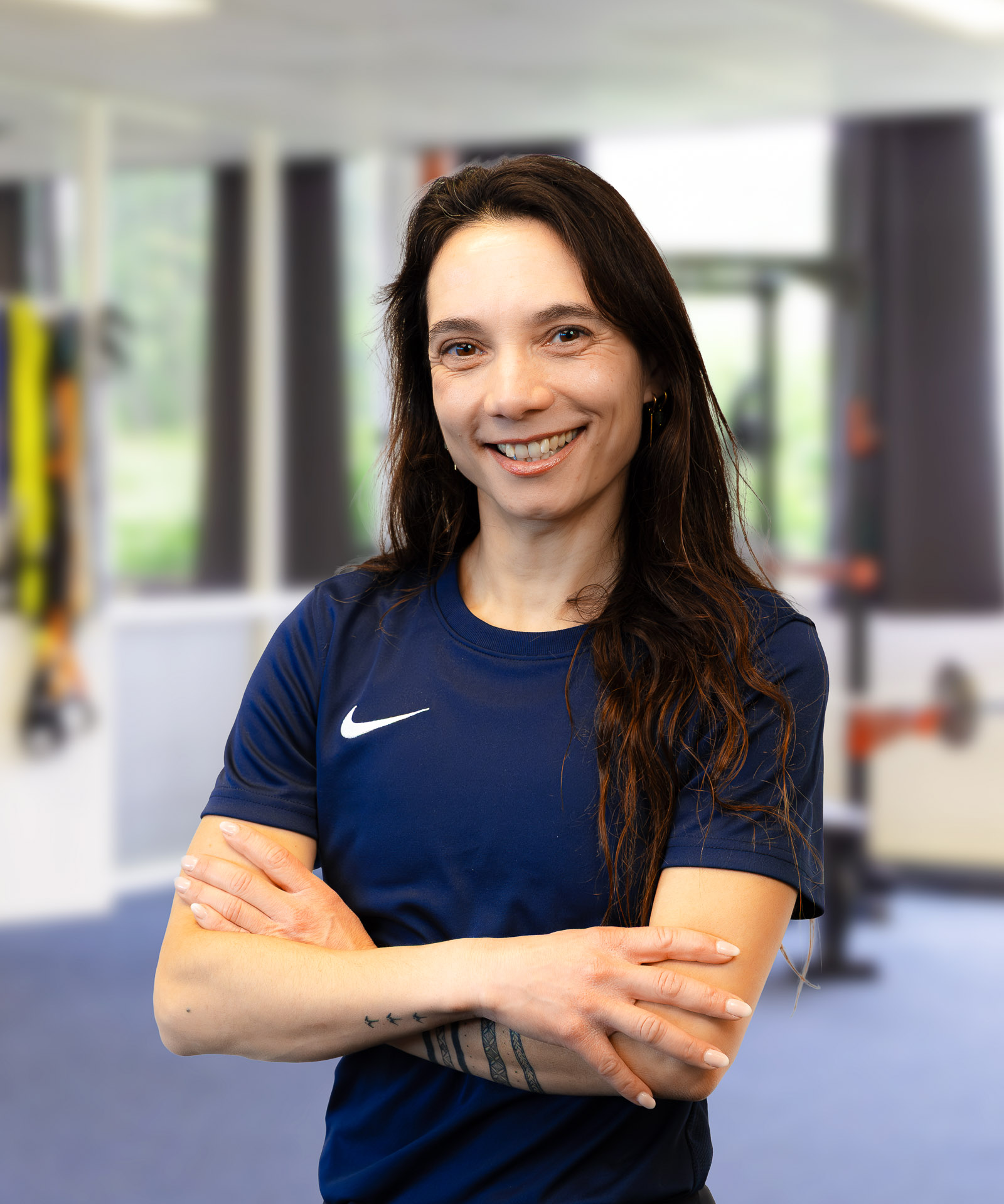 Daisy, personal coach en trainer bij EERLIJK FIT, met de armen over elkaar in de studio